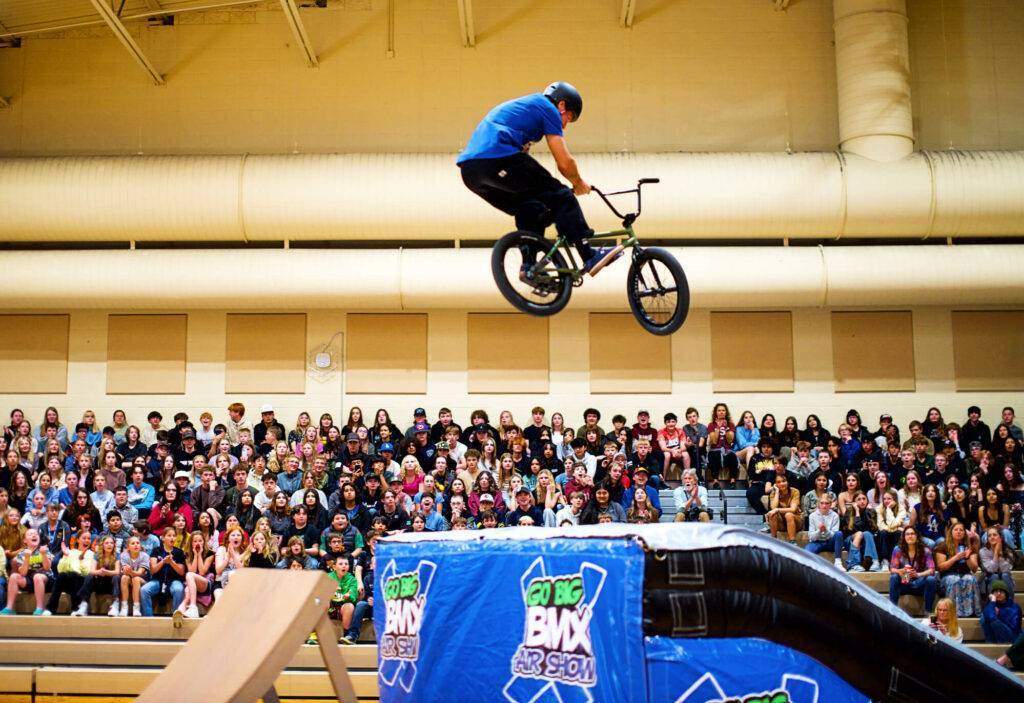 BMX rider performing aerial stunt on ramp at Go Big BMX Air Show